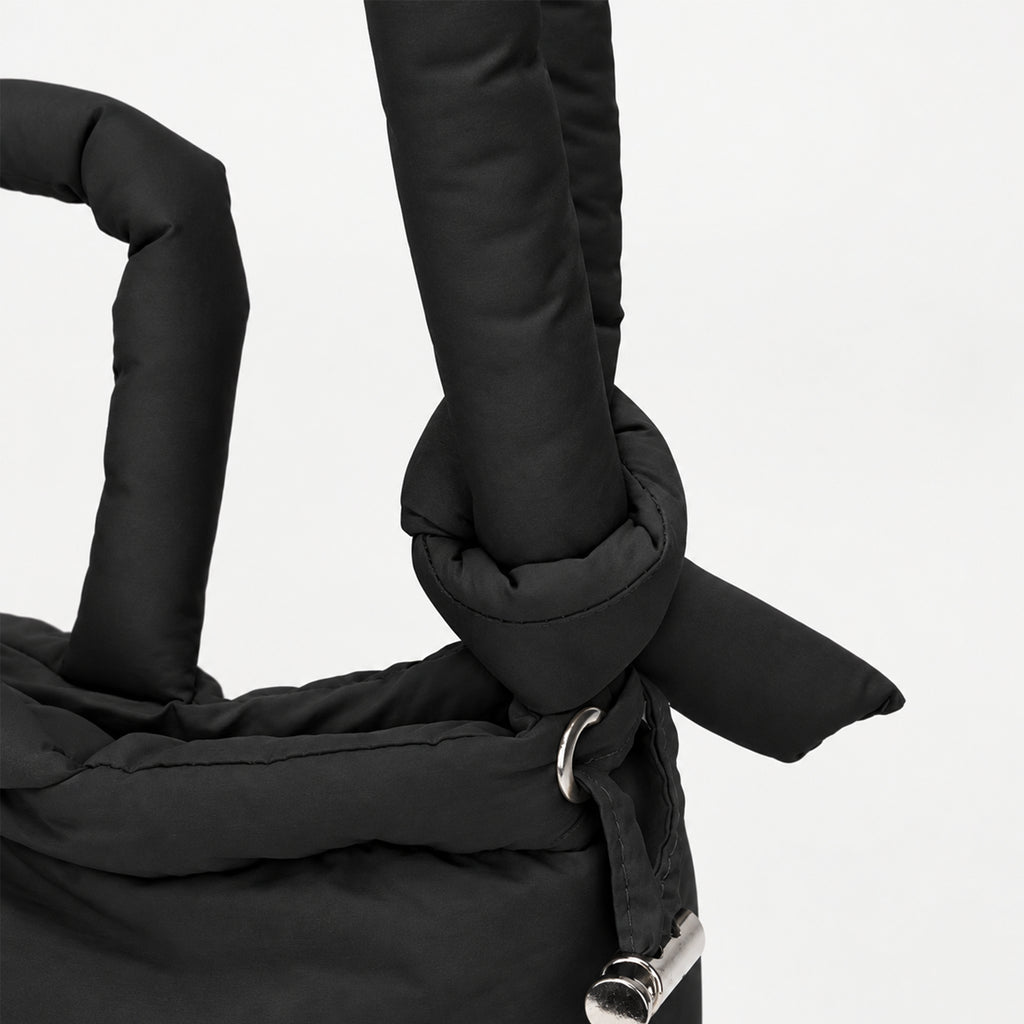 Close-up of the adjustable strap on the black PUFFER Mini multiway tote bag, allowing the carrying length to be adjusted for different wearing styles.