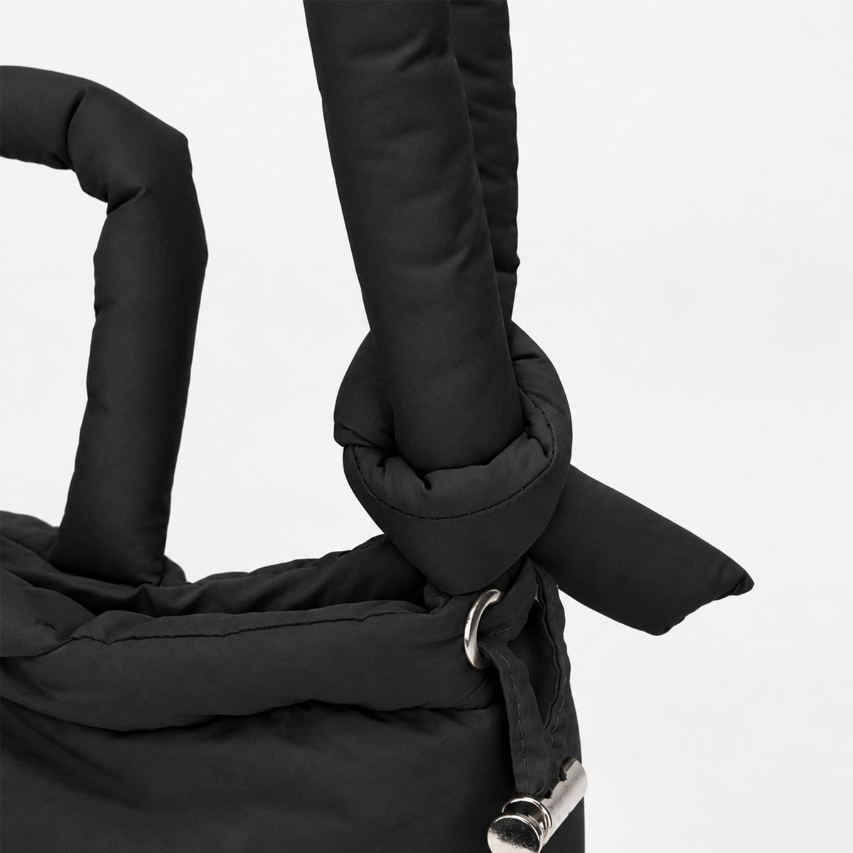Close-up of the adjustable strap on the black PUFFER Mini multiway tote bag, allowing the carrying length to be adjusted for different wearing styles.