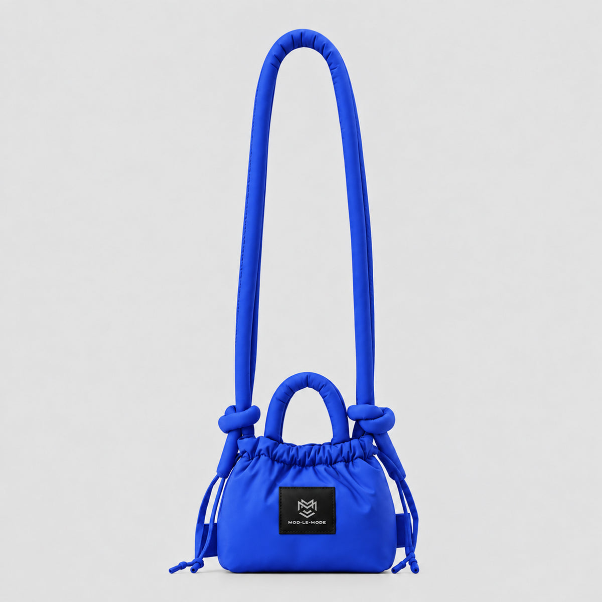 Blue MOD-LE-MODE PUFFER Mini multiway convertible tote bag with drawstring closure, adjustable shoulder strap and front logo patch, photographed in a studio.