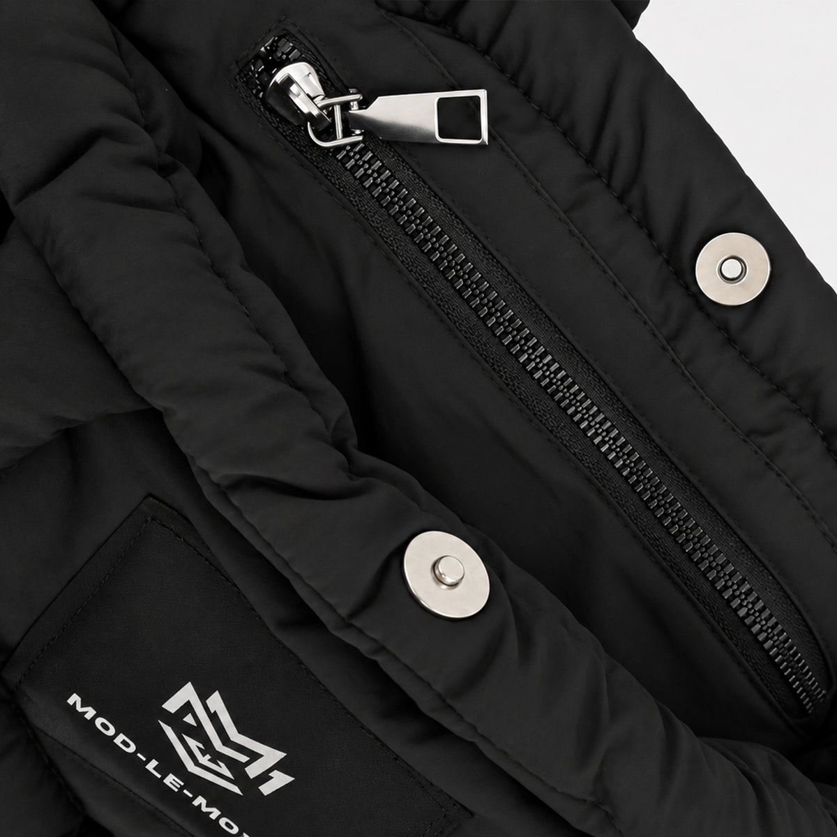 Close-up of the internal zip pocket inside the black MOD-LE-MODE PUFFER Mini tote bag, providing secure storage for everyday essentials.