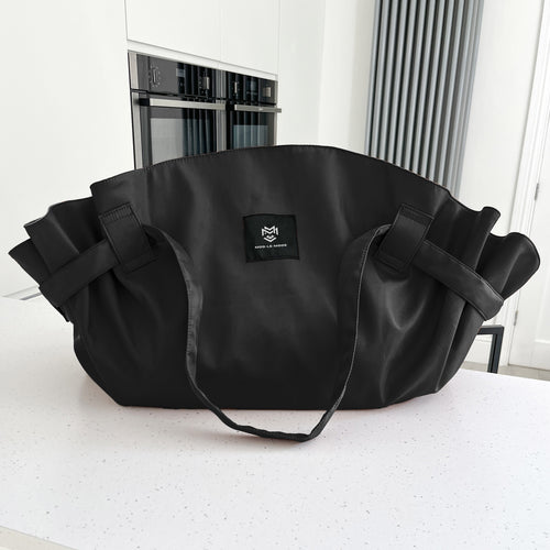 Black MOD-LE-MODE OYSTER lay-flat carry-all tote bag with wide straps on a white kitchen countertop