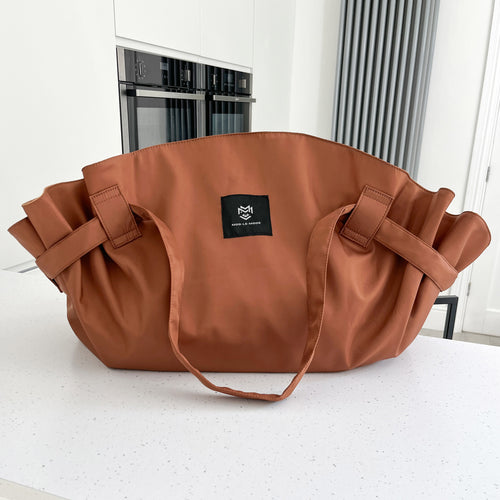 Cinnamon Brown MOD-LE-MODE OYSTER lay-flat carry-all tote bag with wide straps on a white kitchen countertop