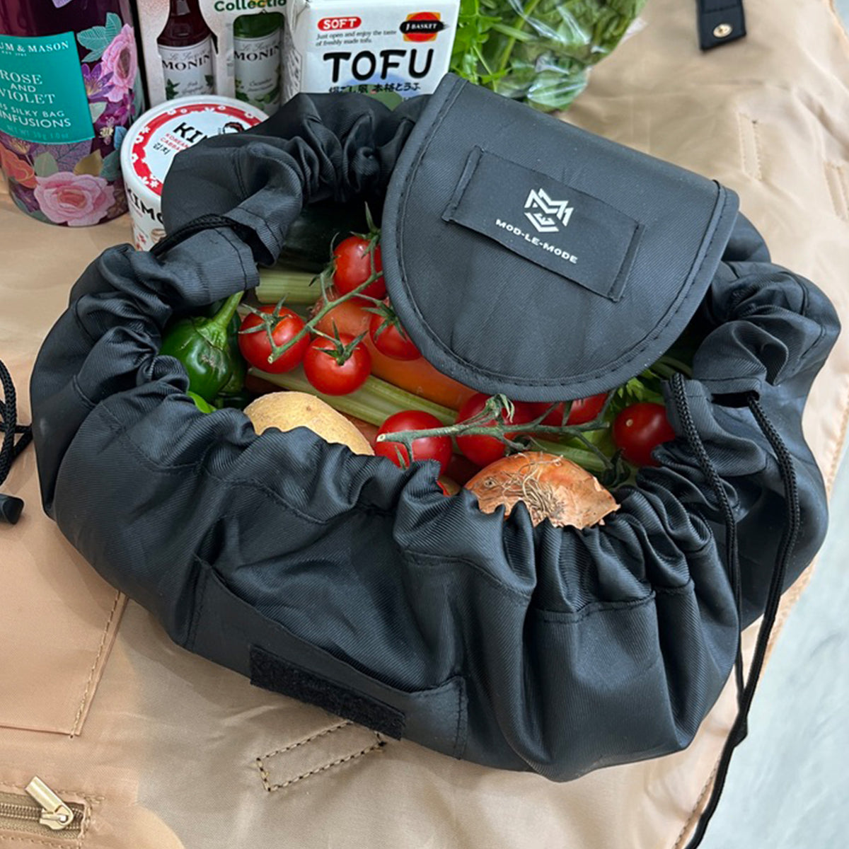 MOD-LE-MODE URCHIN lay-flat drawstring pouch filled with loose fruit and vegetables for grocery shopping